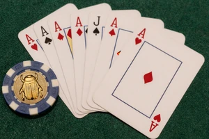 Blackjack-Karten auf dunklem Filz mit goldenem Skarab&auml;en-Pokerchip - Tischspiele bei Cleobetra